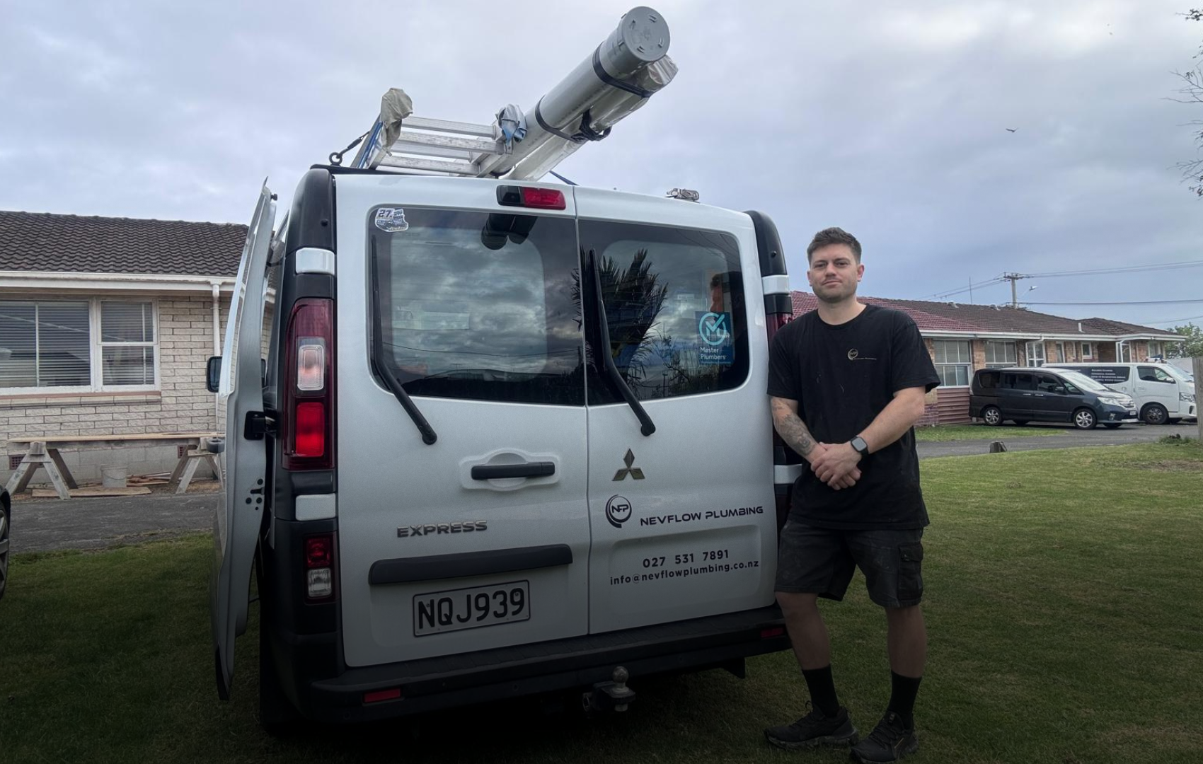 Jordan from Nevflow Plumbing standing beside his service van